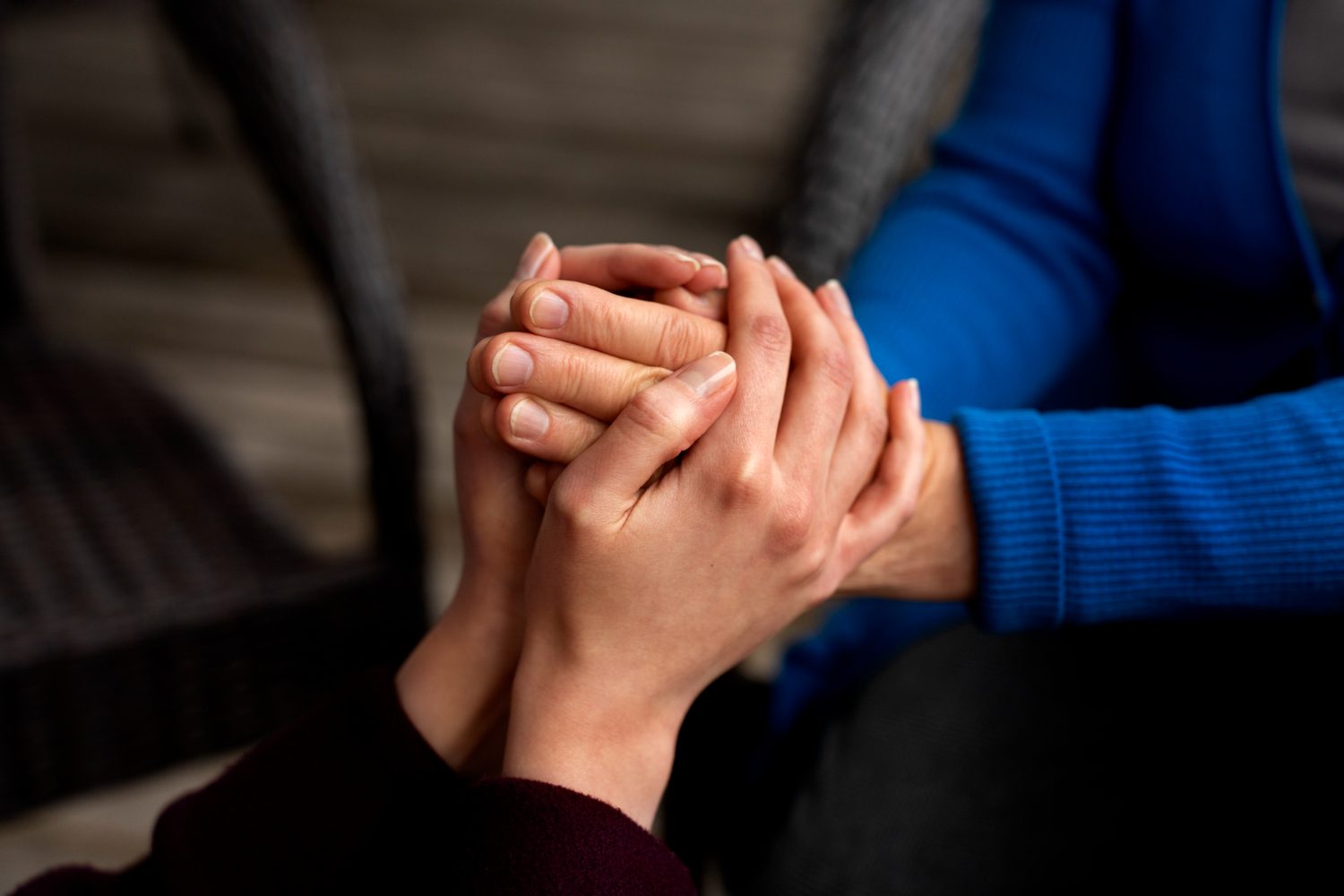 Hands holding each other for support